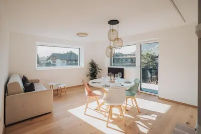 a living room with a table and chairs at Apart Suites Gravbach in Lagundo