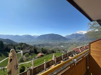 a view of the mountains from the balcony of a house at Hotel Rastlhof in Schenna