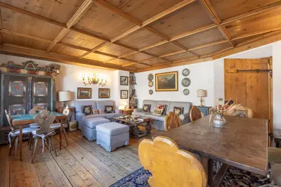 a living room with a couch and a table at Casa Cristallino, in centro con balcone panoramico in Cortina dʼAmpezzo