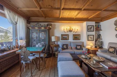 a living room with a couch and a table at Casa Cristallino, in centro con balcone panoramico in Cortina dʼAmpezzo