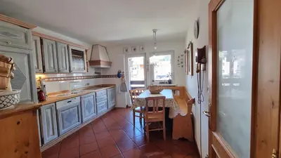 a kitchen with a table and a counter top at Anto in Campitello di Fassa