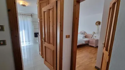 a hallway with an open door to a bedroom at Anto in Campitello di Fassa