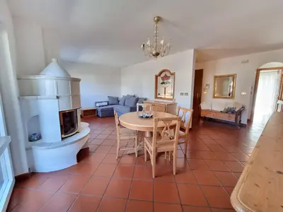 a living room with a table and a fireplace at Anto in Campitello di Fassa