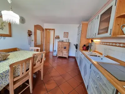 a kitchen with a table and a counter top at Anto in Campitello di Fassa