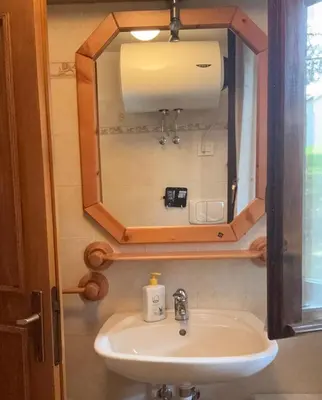 a bathroom with a sink and a mirror at Il Moro di Cavalese in Castello di Fiemme