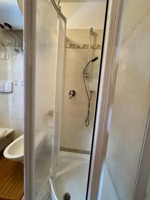 a bathroom with a shower with a glass door at Il Moro di Cavalese in Castello di Fiemme
