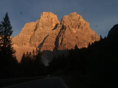 a large mountain in the middle of a road at la fusinela in Selva di Cadore