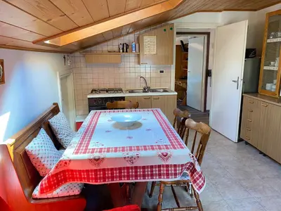 a kitchen with a table with a red and white table cloth at Appartamento Franca in Pera