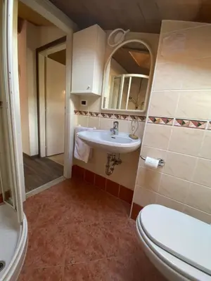 a bathroom with a toilet and a sink at Appartamento Franca in Pera