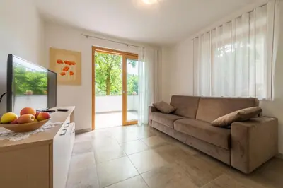 a living room with a couch and a television at Quellenhof in Appiano sulla Strada del Vino