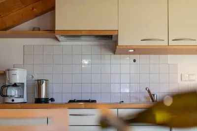 a kitchen with white tiled walls and a counter top at Quellenhof in Appiano sulla Strada del Vino
