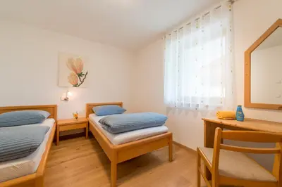 a room with two twin beds and a window at Quellenhof in Appiano sulla Strada del Vino