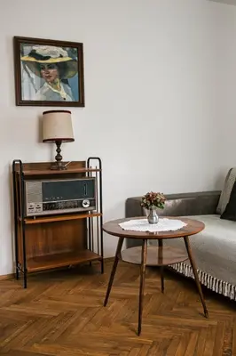 a living room with a couch and a table at Cafe Rudi Living Apartements in Parcines