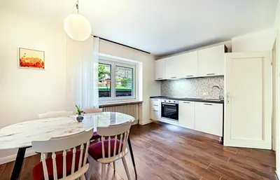 a kitchen with a table and chairs in a room at Cafe Rudi Living Apartements in Parcines