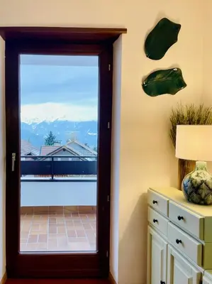 a door to a balcony with a view of the mountains at Apartment in South Tyrol with a beautiful panoramic view in Verano