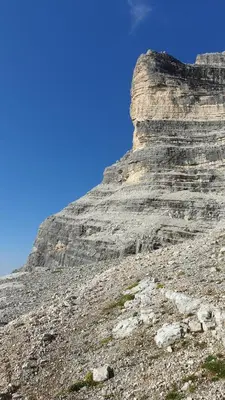 a rocky mountain with a blue sky in the background at Residence Panorama in Val di Zoldo