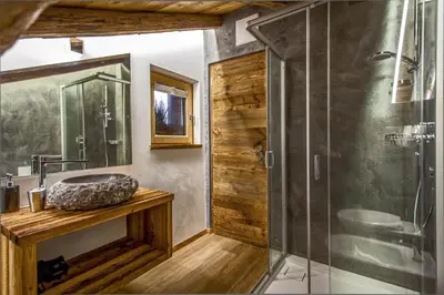 a bathroom with a sink and a glass shower at Chalet Stefan - Apartments in La Villa
