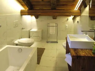 a bathroom with a toilet and a sink and a tub at Chalet Stefan - Apartments in La Villa