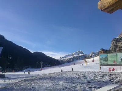 a group of people skiing down a snow covered slope at Chalet Stefan - Apartments in La Villa
