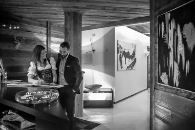 a man and a woman sitting at a table at Chalet Stefan - Apartments in La Villa