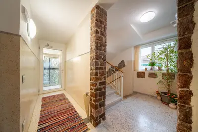 a hallway with a brick pillar and a staircase at Gardar in Bolzano