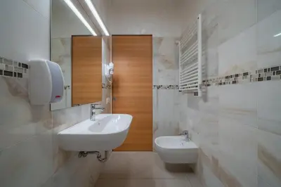 a bathroom with a white sink and a mirror at Gardar in Bolzano