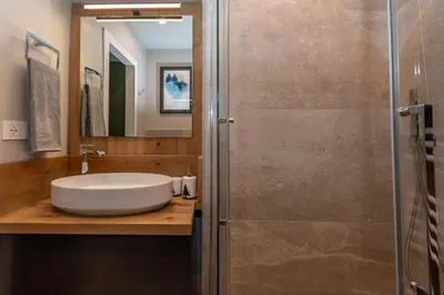 a bathroom with a sink and a shower at Casa Te Volto in Moena