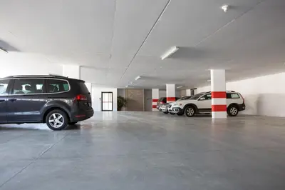 a parking garage with two cars parked in it at Hotel Föhrenhof in Naz-Sciaves