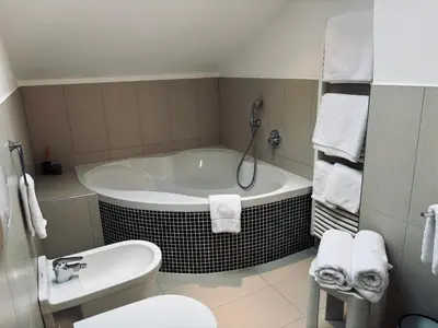 a bathroom with a tub and a toilet and a sink at Bergchalet Platzl in Verano