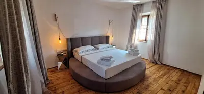 a bedroom with a large bed with a large headboard at Santer Klause in Merano