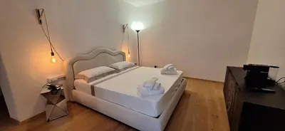 a bedroom with a white bed with towels on it at Santer Klause in Merano