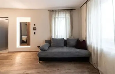 a living room with a couch in front of a window at Santer Klause in Merano