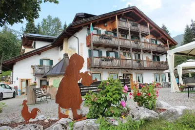 a statue of a person in front of a house at Rifugio Caltena in Fiera di Primiero