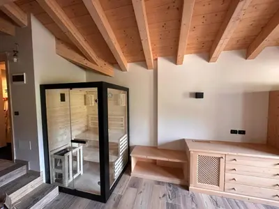 a room with a glass elevator and wooden ceilings at Rifugio Caltena in Fiera di Primiero