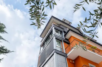 an orange building with windows on top of it at Gardar Studio Fox in Bolzano