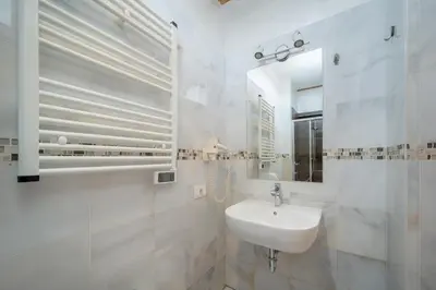 a white bathroom with a sink and a mirror at Gardar Studio Fox in Bolzano