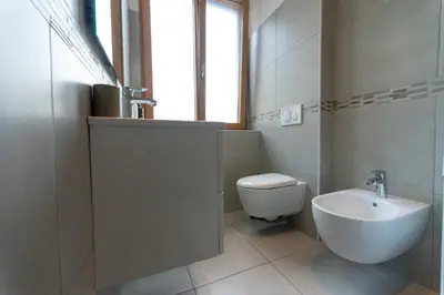 a bathroom with a shower and a toilet and a sink at BozenApartments Garibaldi in Bolzano