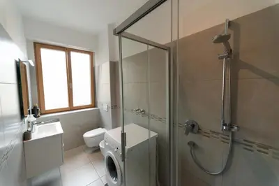 two doors in a room with white walls at BozenApartments Garibaldi in Bolzano
