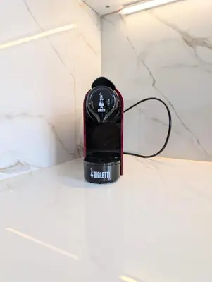 a black and red blender sitting on a counter at BozenApartments Garibaldi in Bolzano