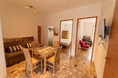 a living room with a table and a couch at BozenApartments Garibaldi in Bolzano
