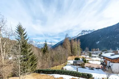 a village in the mountains with snow on the ground at Ciasa al Sol in Falcade