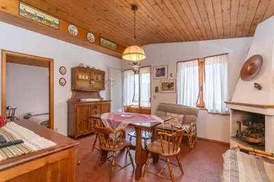 a kitchen and dining room with a table and chairs at Ciasa al Sol in Falcade