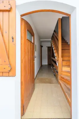 a hallway with wooden stairs in a house at Ca' dello Scoiattolo in Cortina dʼAmpezzo