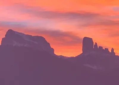 a painting of a sunset in the mountains at Ca' dello Scoiattolo in Cortina dʼAmpezzo