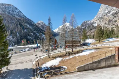 a building in the mountains with snow covered mountains at Principe Marmolada 154 in Rocca Pietore