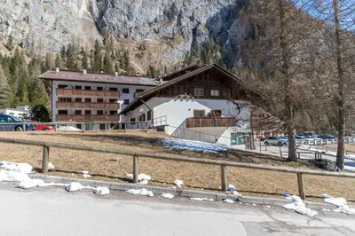 a building with a car parked in front of it at Principe Marmolada 154 in Rocca Pietore