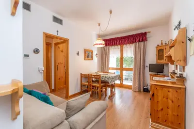 a living room with a couch and a table at Appartamento Cordevole in Rocca Pietore