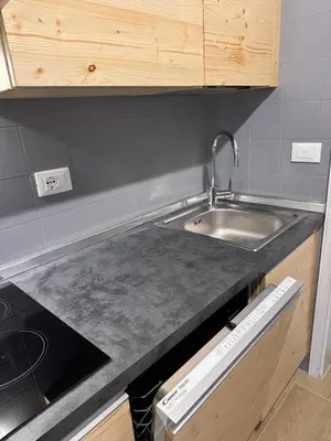 a kitchen with a sink and a counter top at Ciasa Saslonch Apartment in Moena