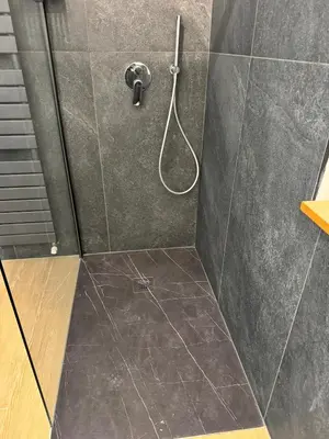 a bathroom with a shower with a shower head at Ciasa Saslonch Apartment in Moena