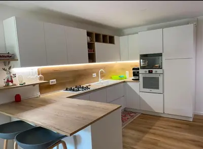 a kitchen with white cabinets and a counter top at Appartamento Miramonti in Mas